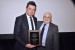 Dr. Nagib Callaos, General Chair, giving Dr. Pawel Poszytek a plaque "In Appreciation for Delivering a Great Keynote Address at a Plenary Session."